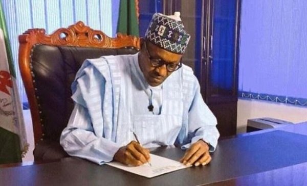 President Muhammadu Buhari signs a document