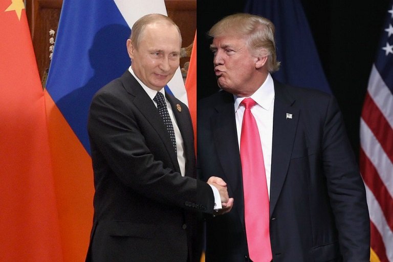 Vladimir Putin shake hands with Donald Trump in a file photo