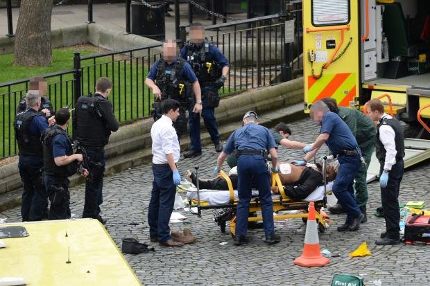 Terror attacks: London police with an injured person at Wetminster.