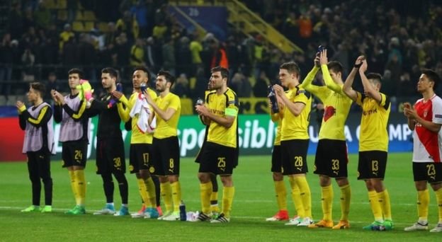 Dortmund players applaud the fans after their defeat
