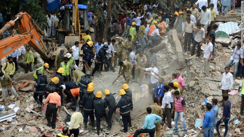 Rescue workers look for survivors in debris at the site of a building collapse in Mumbai