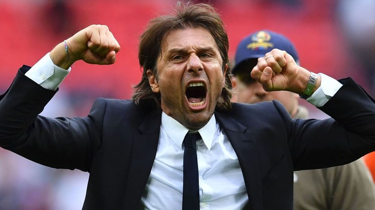 Antonio Conte celebrates on the pitch at the end of the game against Spurs