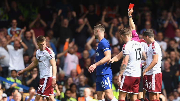 Gary Cahill is sent off by referee Craig Pawson after a high challenge on Steven Defour