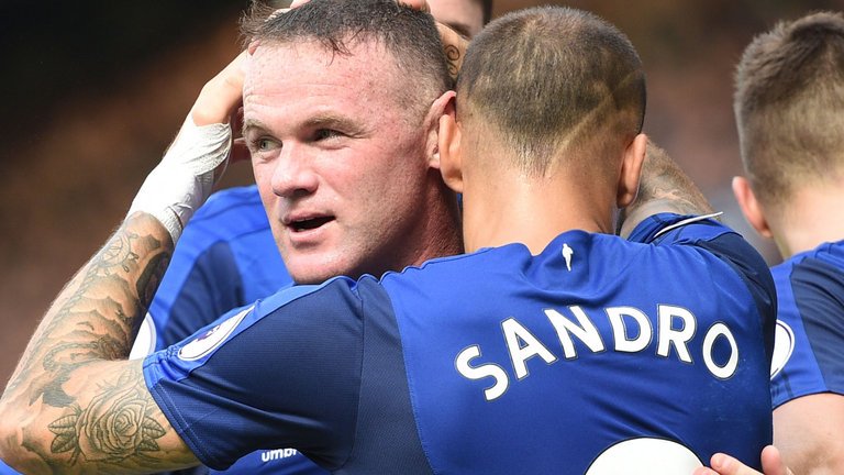 Wayne Rooney is congratulated by his team-mates after scoring