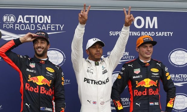  Mercedes’s Lewis Hamilton, centre, celebrates pole position, between Daniel Ricciardo, left, who is third and his Red Bull team-mate Max Verstappen, second