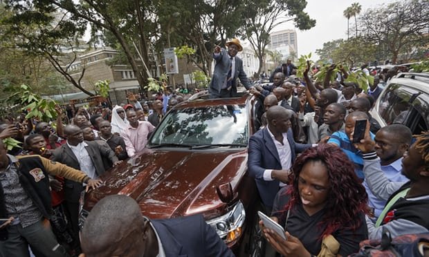 Odinga waves to supporters as he leaves the supreme court. Election to hold again 