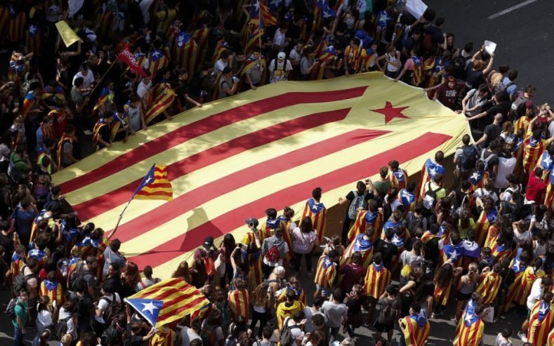 Students carry a big Estelada (Pro-independence Catalan flag) as they march during a pro-referendum demonstration called by students on September 28, 2017 in Barcelona.