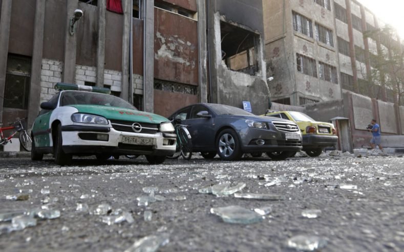 Debris lie on the ground at the site of a double suicide bomb attack which hit the al-Midan police station in Syria's capital Damascus