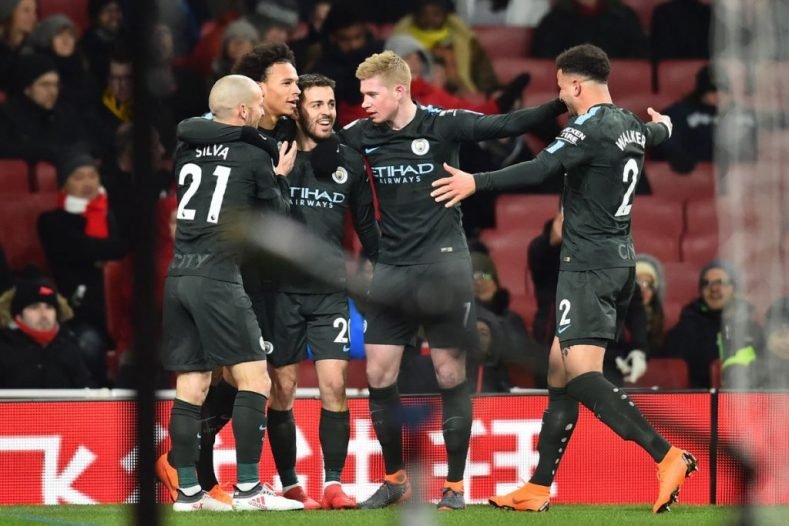 Man City players celebrate scoring the second goal at Arsenal
