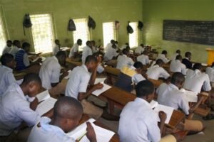 Students writing WAEC exam in a supervised classroom without malpractice