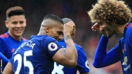Antonio Valencia and Marouane Fellaini celebrate victory following Valencia's late goal