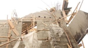 Rescue workers and officials at the scene of the collapsed entrance canopy at the Gombe State House of Assembly Complex construction site.
