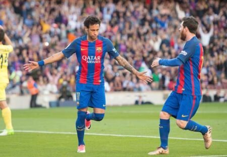 Neymar and Lionel Messi celebrate after Barcelona score against Villarreal