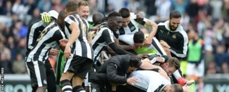 Newcastle players celebrate their victory at the final whistle