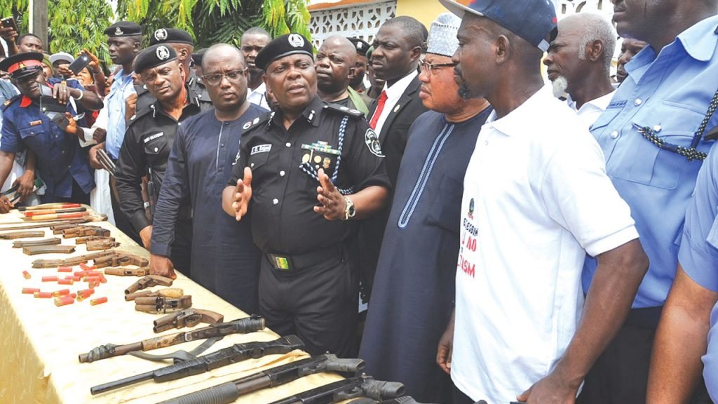 The Commissioner of Police, Edgal Imohimi (middle), receiving the weapons yesterday in Ikorodu