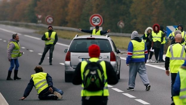 A driver forces a car through a group of protesters in Donges, western France