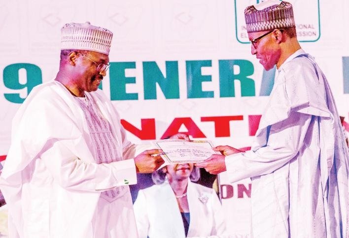 Prof. Mahmood Yakubu presenting President Muhammadu Buhari with his Certificate of Return