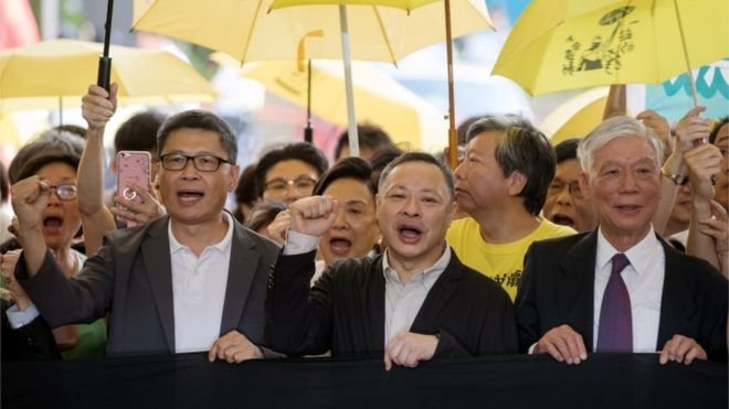 Hong Kong Chan Kin-man, left, and Benny Tai, centre, was jailed for 16 months while Chu Yiu-ming, right, got a suspended sentence