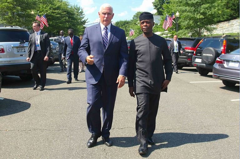 Vice President Mike Pence walking Vice President Yemi Osinbajo to his car after a meeting at the White House