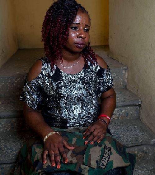 Mercy Tamuno in Abuja, Nigeria, with her husband’s uniform. Officials told her he was killed in an insurgent attack on an outpost in the country’s northeast