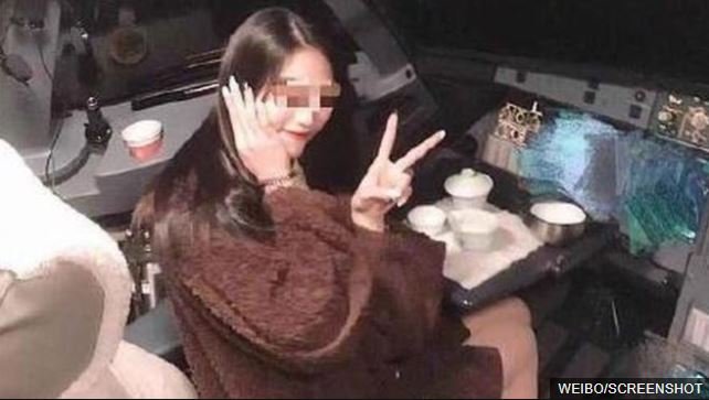 Pilot banned for life after woman’s cockpit photo The female passenger is seen here with her fingers in a V pose, also known as the peace sign