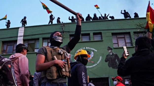 Several uniformed police officers were pictured waving flags and signs on the roofs of police stations