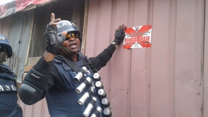 Operatives of the Lagos Taskforce, pasting removal order on illegal structures in Lekki