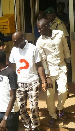 Prince Adewale Oyekan, 50, (right) and his accomplice Lateef Balogun, 27, leaving court on Monday after being sentenced