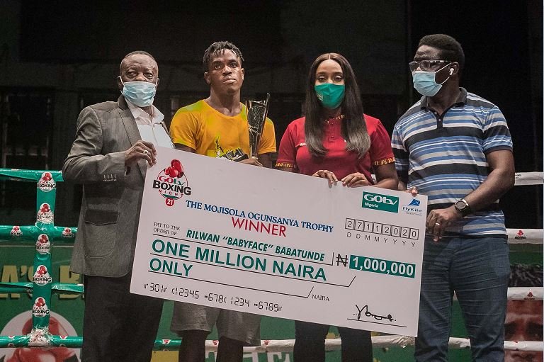 L-R; President of the Nigerian Boxing Board of Control (NBB of C), Mr. Rafiu Ladipo; Best Boxer GOtv Boxing Night 21, Rilwan "Babyface" Babatunde; Public Relations Manager, GOtv, Jennifer Ukoh and Director-General, Lagos State Sports Commission, Mr. Gafaar Oluwatoyin Bolowotan, presenting the best boxer award at the GOtv Boxing Night 21 on Friday