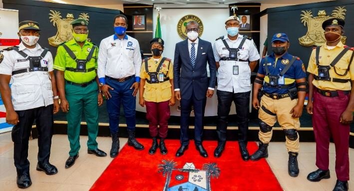 Governor Babajide Sanwo-Olu poses with law enforcement officers wearing body cams