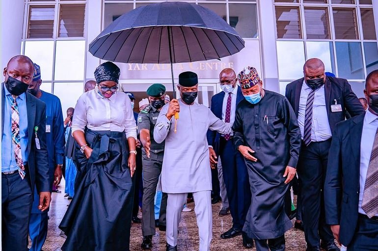 Between Osinbajo’s umbrella and the power bank Vice President Yemi Osinbajo holds an umbrella over his head and that of HMS Science & Tech Mohammed Abdullahi and Senator Ekwunife as they depart Musa Yaradua Center after he launched National Leather and Leather Products Policy Implementation Plan at the Musa Yaradua Centre in Abuja