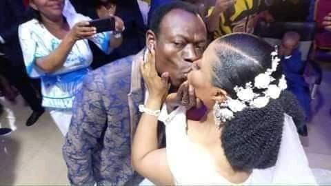 Pastor Moses Adeeyo kissing his bride, Tina on their wedding day