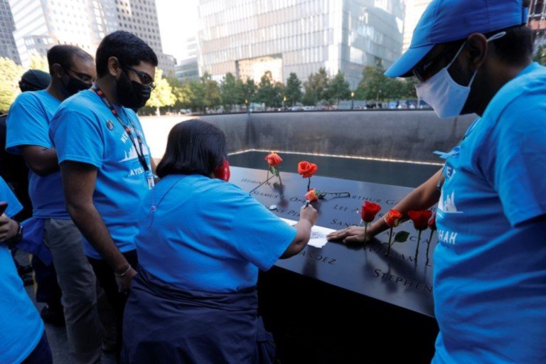 Family members of Jayesh Shah make a rubbing of his name at the 9-11 Memorial on the 20th anniversary of the September 11 attacks in Manhattan, New York City, U.S., September 11, 2021