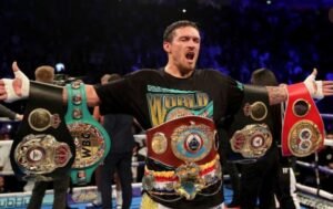 Oleksandr Usyk poses with his WBA, WBO, IBF and IBO belts