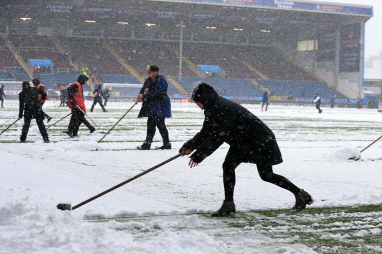 Officials try to clear the heavy snow