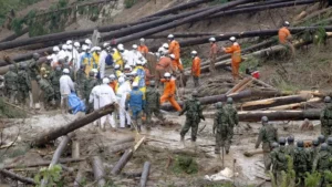 Philippines floods, landslides kill 13 after record rainfall Rescuers search through rubble after a landslide in Baguio City, Philippines.
