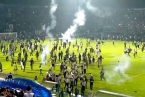 Fans invade the football field after a match between Arema FC and Persebaya Surabaya at Kanjuruhan Stadium, Malang, Indonesia