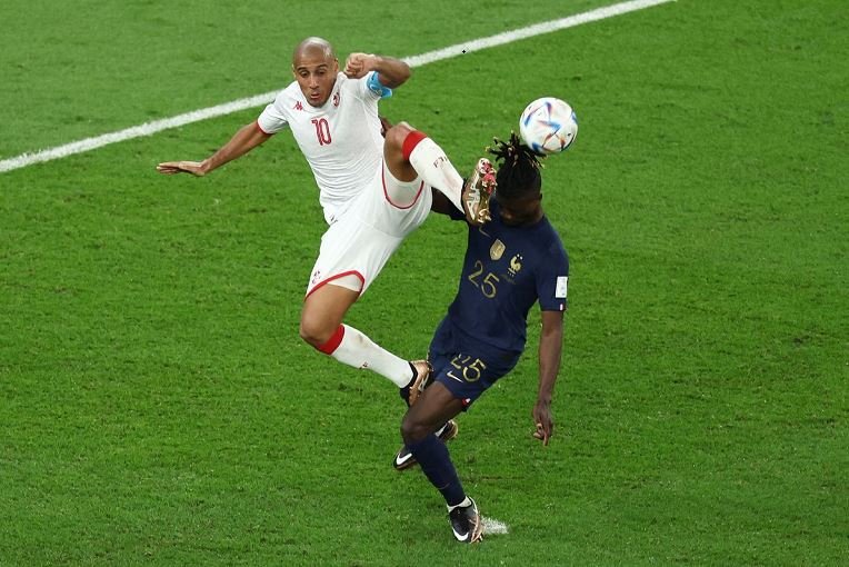 Tunisia's Wahbi Khazri in action with France's Eduardo Camavinga