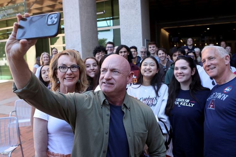 democrats Democrat US Senator Mark Kelly and his wife Gabby Giffords take a selfie at a campaign event ahead of the November 8, 2022 U.S. midterm elections in Tucson, Arizona