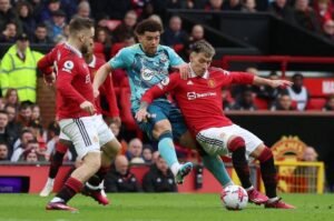 Southampton's Che Adams in action with Manchester United's Lisandro Martinez
