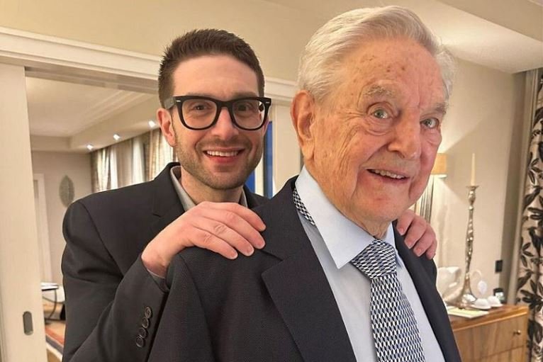Billionaire George Soros hands empire to son Alex Alex Soros is seen with his father George Soros, in Munich, Germany in this picture obtained from social media and released February 16, 2023 by Alex Soros via Twitter
