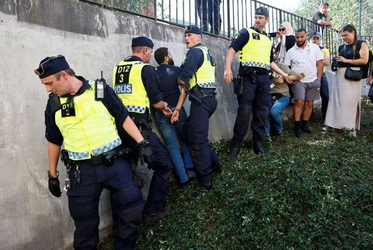 Protester burns Koran at Stockholm mosque on Eid holiday Protesters loot shops as UK riot worsens