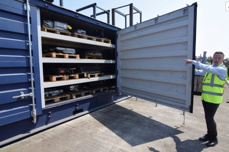 Marc Trent, CEO of vehicle dismantler company Charles Trent Ltd, opens up a specially-built, fire-safe container for batteries salvaged from written-off electric vehicles and hybrids in Poole, Britain, June 7, 2023. REUTERS/Nick Carey