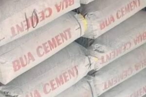 Stacks of cement bags displayed for sale at a building materials market in Nigeria.
