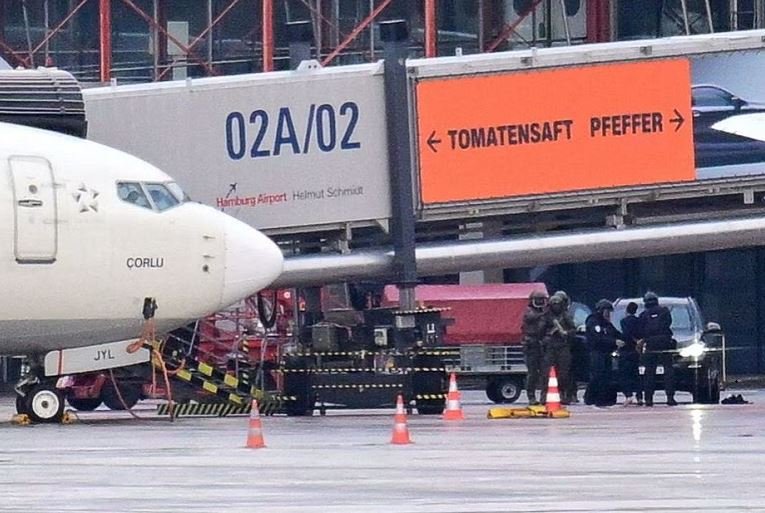 Police officers detain a man, after a man drove through a barrier onto the grounds of the city's airport with a child in his car in Hamburg, Germany, November 5, 2023. REUTERS/Fabian Bimmer