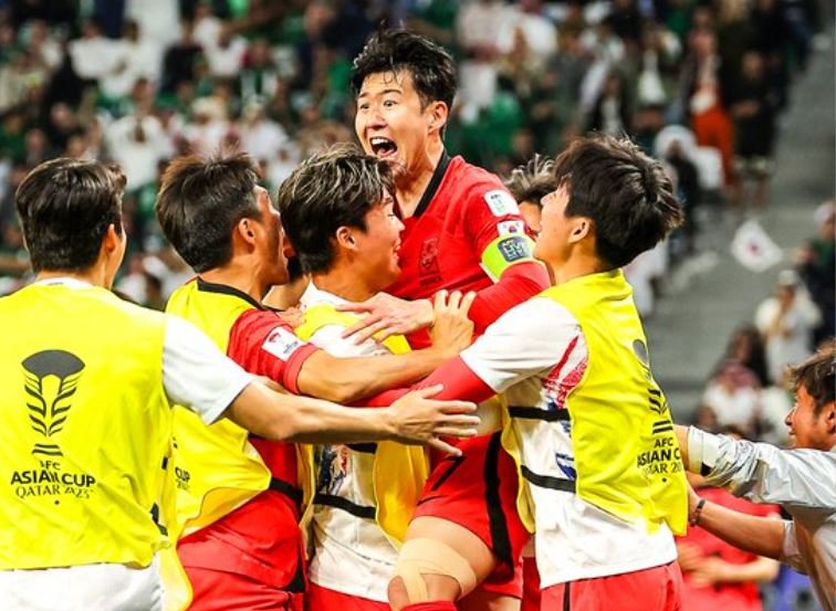 Asian Cup South Korea captain Son Heung-min celebrates with teammates as they progressed to the last eight