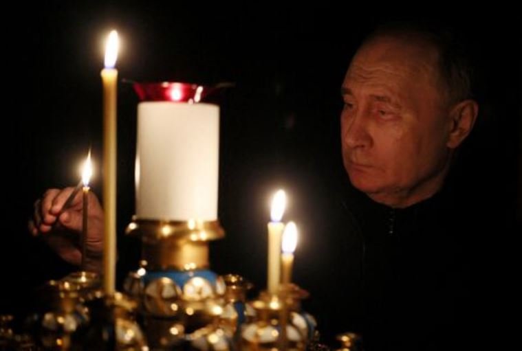 President Vladimir Putin lights a candle in memory of the victims of the Crocus City Hall attack, on the day of national mourning in a church at the Novo-Ogaryovo state residence outside Moscow, Russia March 24, 2024.