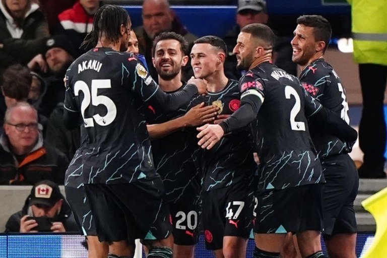 Phil Foden, centre, scored twice at Brighton to help Manchester City move a point behind Premier League leaders Arsenal