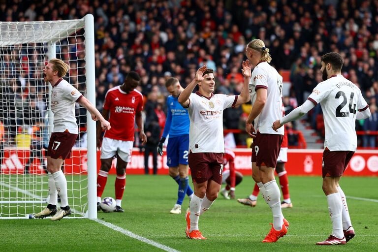 Manchester City cut Arsenal’s gap at the top of the Premier League after a 2-0 win at Nottingham Forest