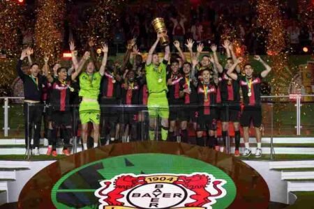 Bayer Leverkusen players lift the trophy to celebrate winning the DFB Cup